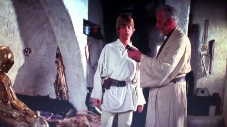 Obi-Wan handing Luke his father's lightsaber
